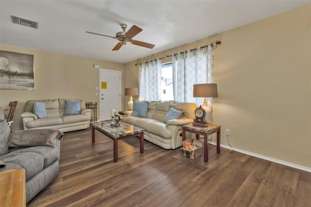 living room featuring dark hardwood / wood-style flooring and ceiling fan