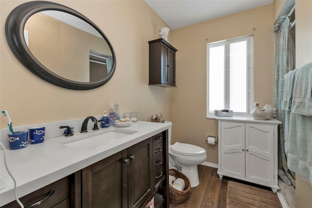 bathroom with hardwood / wood-style floors, vanity, and toilet