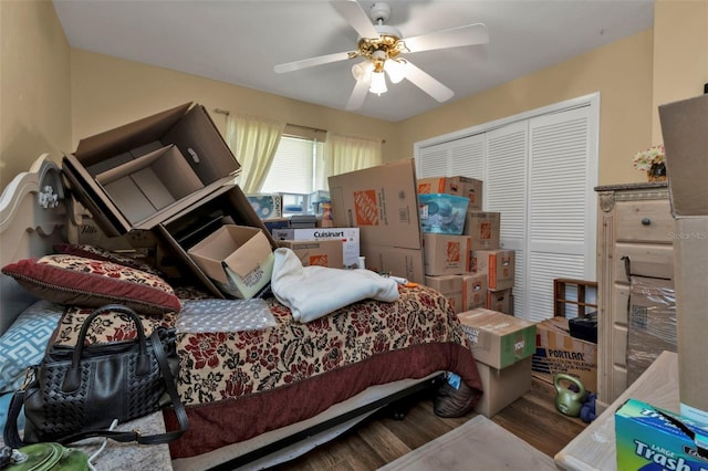 bedroom with ceiling fan, a closet, and wood-type flooring