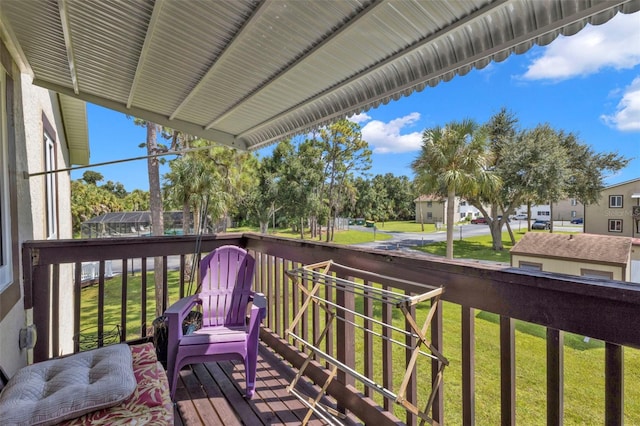 wooden terrace featuring a lawn