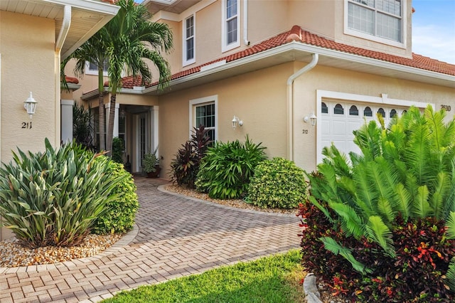 view of exterior entry with a garage