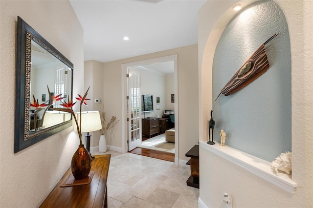 interior space with ornamental molding and light hardwood / wood-style flooring