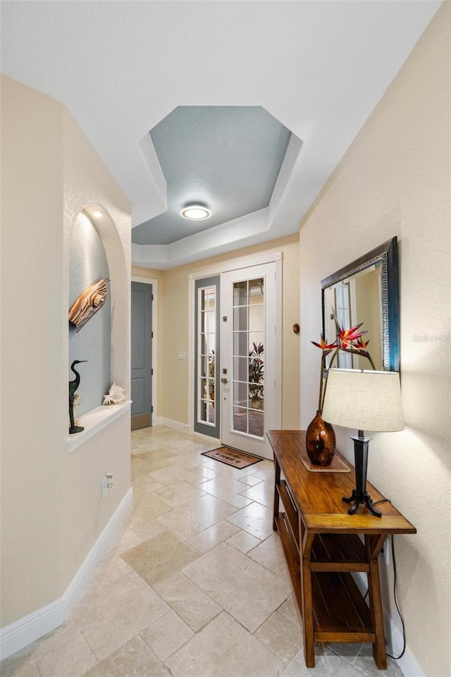 foyer with a raised ceiling