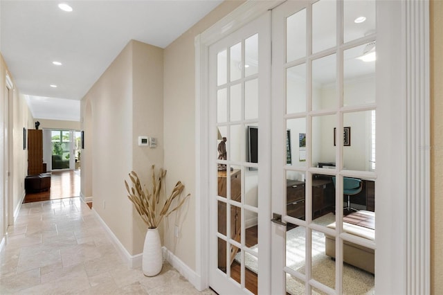 hallway with a barn door and french doors