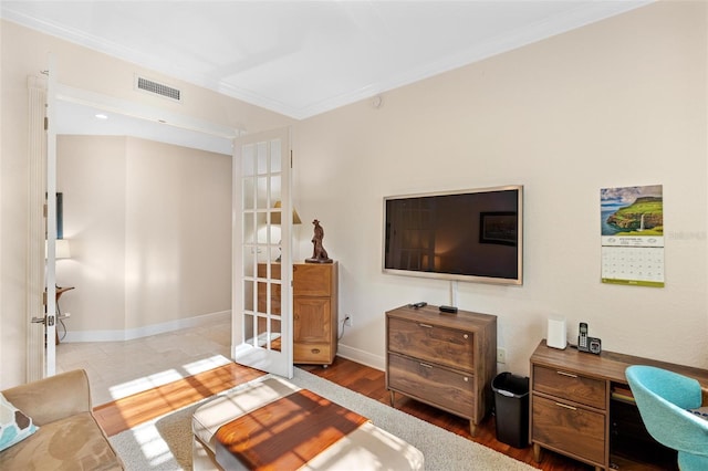 living room featuring crown molding and hardwood / wood-style flooring