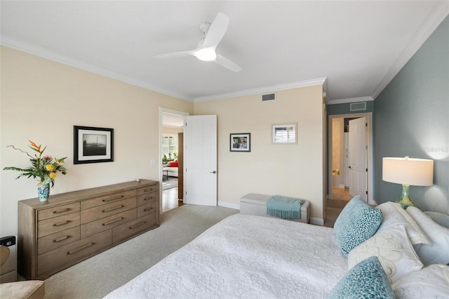 carpeted bedroom with ornamental molding and ceiling fan