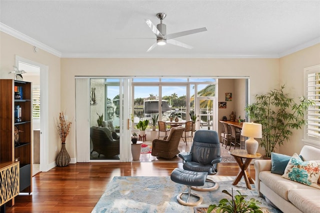 living room featuring ornamental molding, ceiling fan, and dark hardwood / wood-style floors