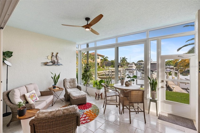 sunroom / solarium featuring ceiling fan