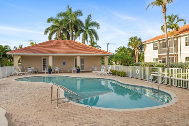 view of pool with french doors and a patio area