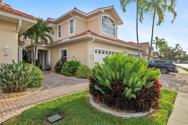 mediterranean / spanish house with a garage