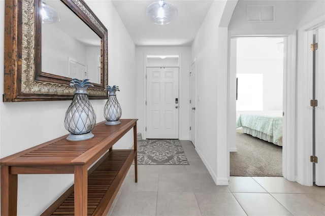 entrance foyer featuring light colored carpet