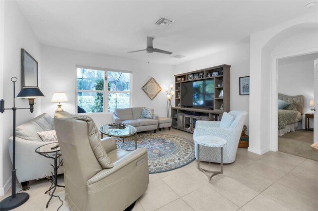 living room featuring ceiling fan and light tile patterned floors