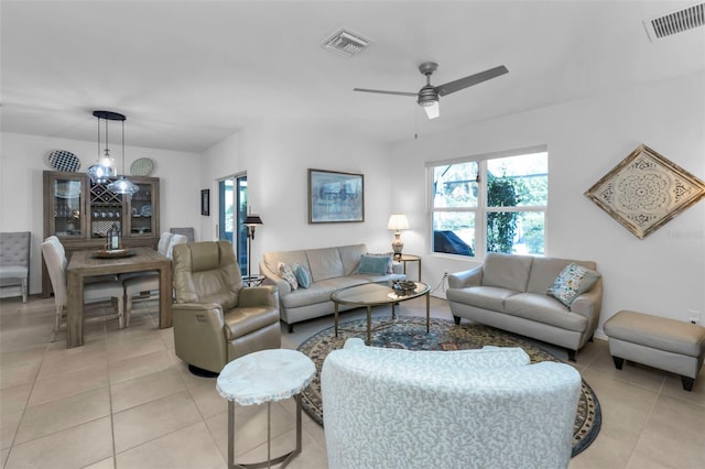 tiled living room with ceiling fan