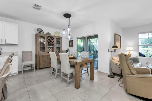 tiled dining area with a chandelier