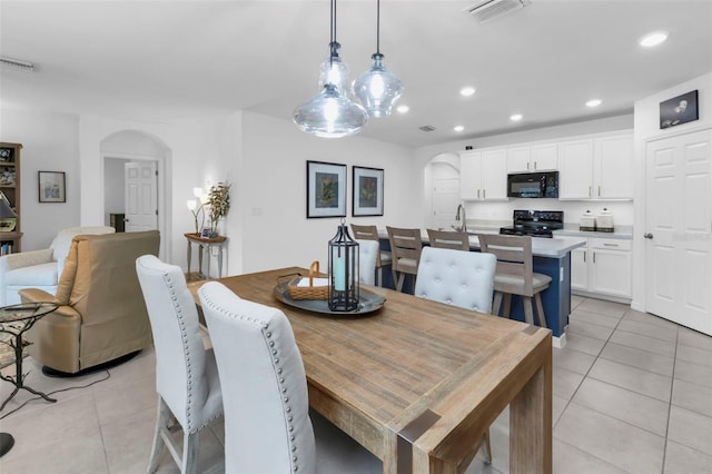 tiled dining area featuring sink