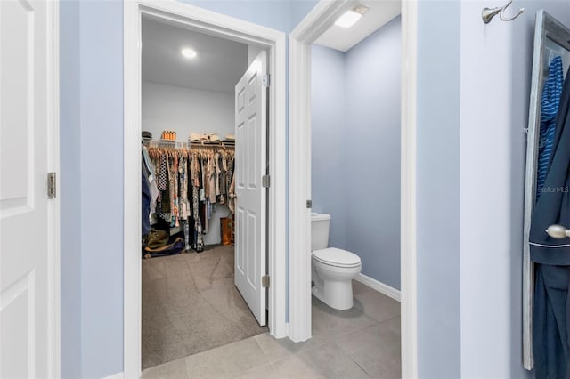 bathroom with toilet and tile patterned floors