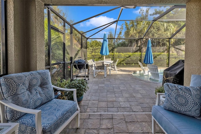 view of patio / terrace with area for grilling and glass enclosure