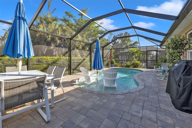 view of pool featuring area for grilling, glass enclosure, and a patio