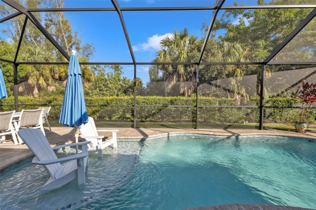 view of swimming pool featuring a patio and a lanai