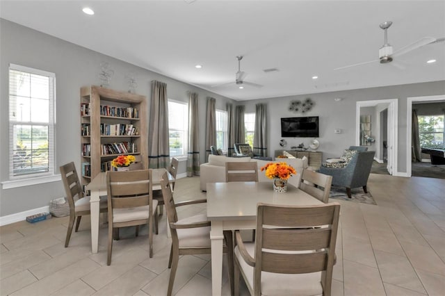 tiled dining space with a wealth of natural light and ceiling fan