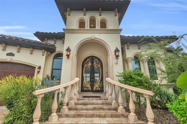 doorway to property featuring a porch and french doors