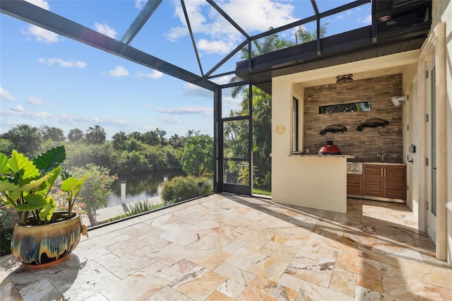 unfurnished sunroom featuring a water view