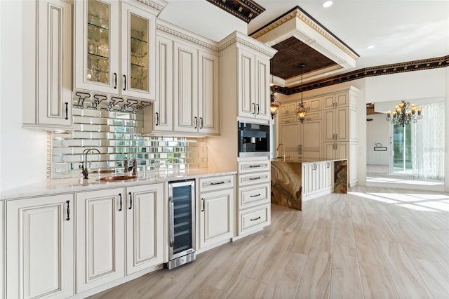 kitchen featuring hanging light fixtures, tasteful backsplash, light stone countertops, black oven, and beverage cooler