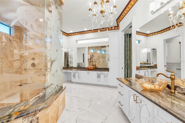 bathroom featuring tiled shower, vanity, and a notable chandelier