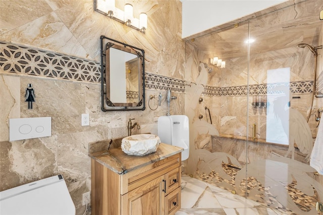 bathroom with vanity, tile walls, toilet, and a shower with door