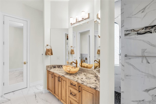 bathroom featuring vanity and tiled shower