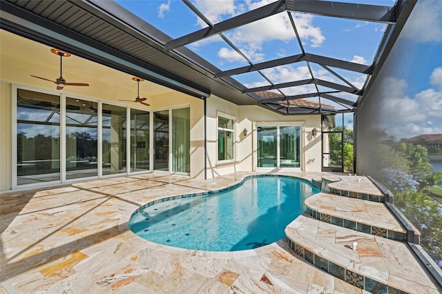 view of pool featuring ceiling fan, a lanai, and a patio area