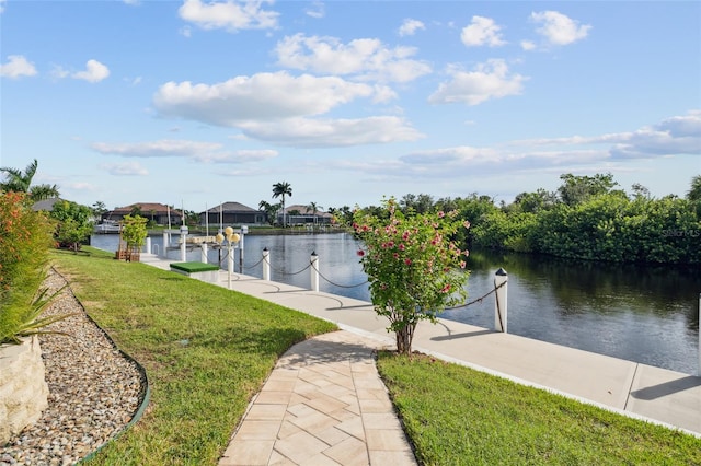 view of dock featuring a yard and a water view