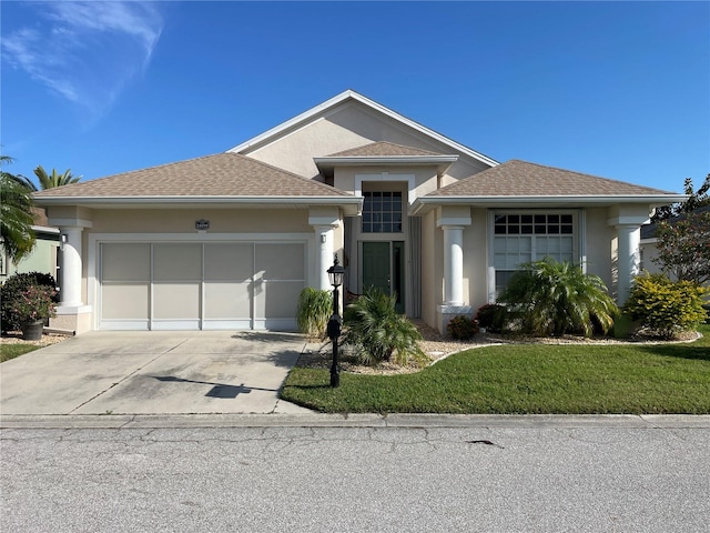 view of front facade featuring a garage and a front lawn