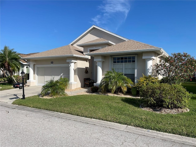 view of front of house with a garage and a front lawn