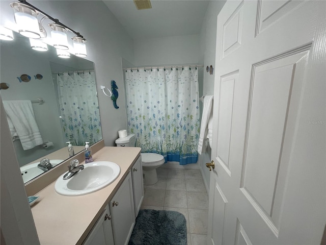 bathroom featuring vanity, toilet, and tile patterned floors