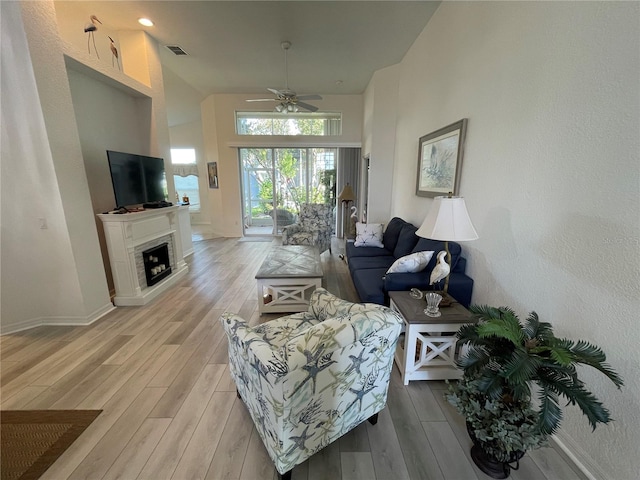 living room featuring ceiling fan and light hardwood / wood-style flooring