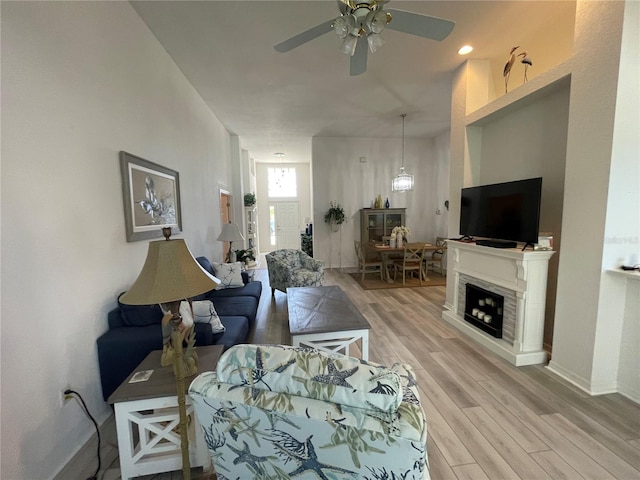 living room featuring ceiling fan and light hardwood / wood-style flooring