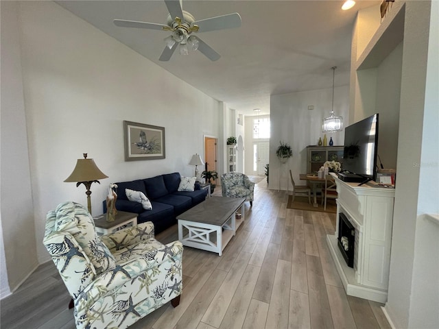 living room featuring ceiling fan and light wood-type flooring