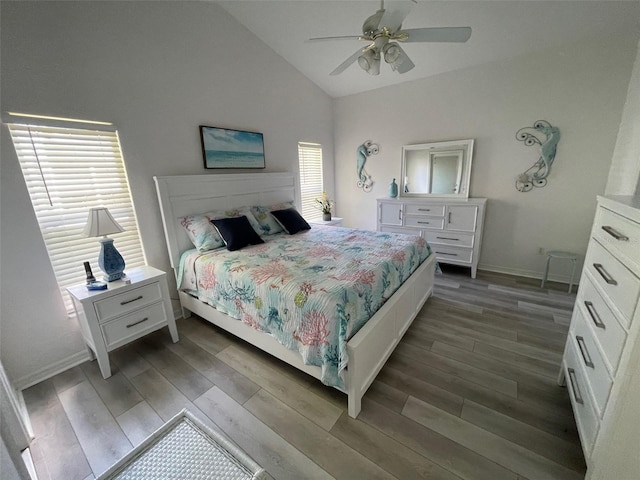 bedroom featuring lofted ceiling, ceiling fan, hardwood / wood-style flooring, and multiple windows