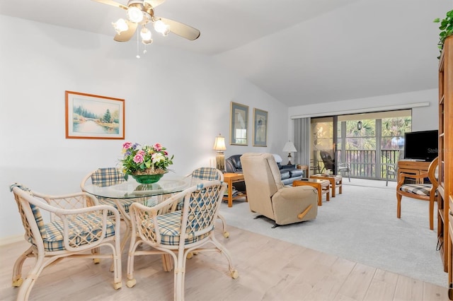 dining area featuring ceiling fan, light hardwood / wood-style flooring, and lofted ceiling