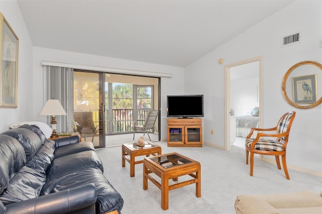 living room featuring vaulted ceiling and light colored carpet