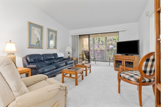 carpeted living room featuring lofted ceiling