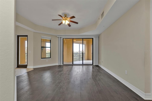 spare room featuring ceiling fan and dark hardwood / wood-style flooring