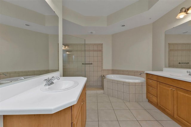 bathroom with tile patterned flooring, vanity, and separate shower and tub