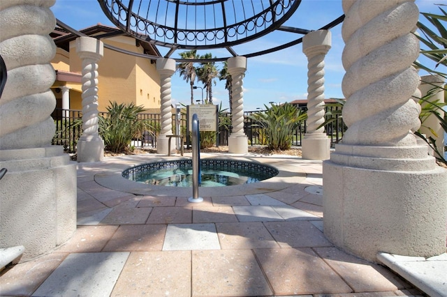 view of swimming pool with an in ground hot tub