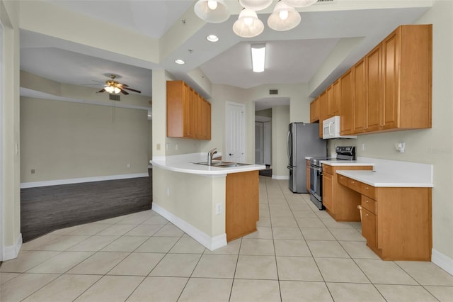 kitchen featuring ceiling fan, sink, light tile patterned flooring, kitchen peninsula, and stainless steel range with electric cooktop