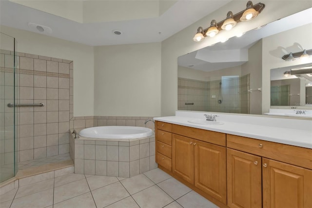 bathroom featuring tile patterned flooring, vanity, and plus walk in shower