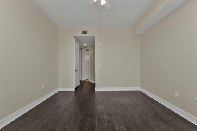 spare room featuring ceiling fan and dark wood-type flooring