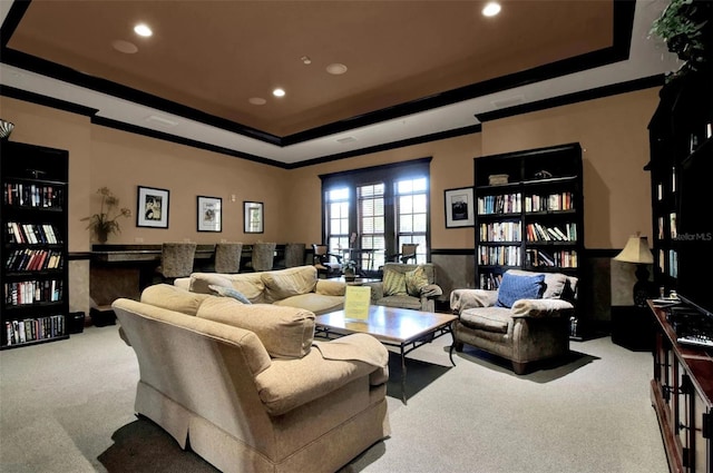 living room featuring carpet, a raised ceiling, crown molding, and french doors