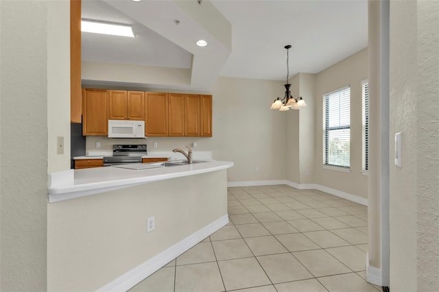 kitchen featuring kitchen peninsula, stainless steel electric range, an inviting chandelier, hanging light fixtures, and light tile patterned flooring